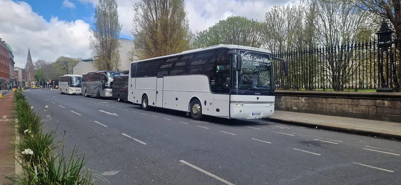 White coach parked with another coach behind it